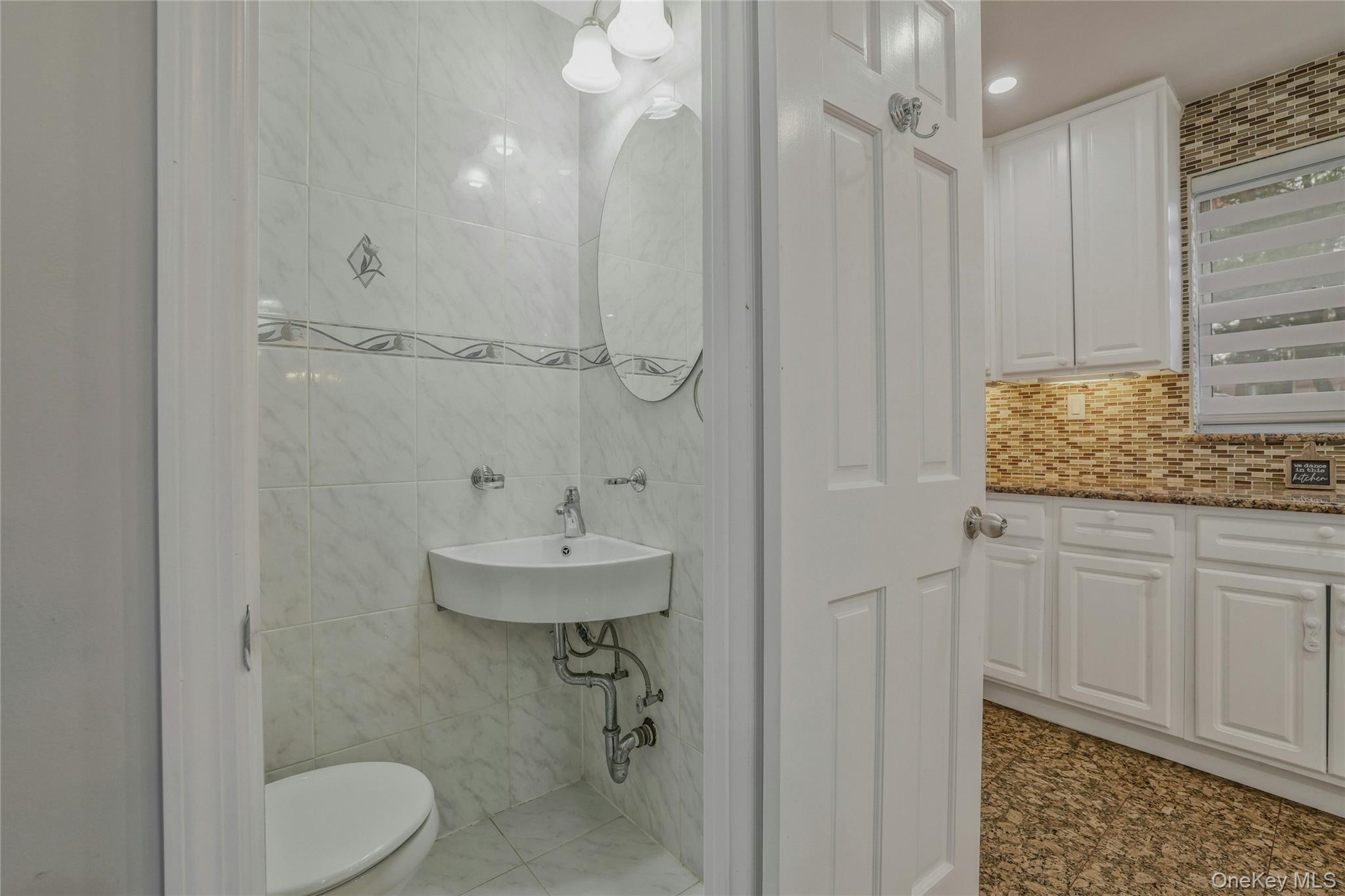 22904 67th Avenue, Unit 38 Queens, NY 11364 - Photo 10 of 17 a bathroom with a granite countertop sink toilet and shower