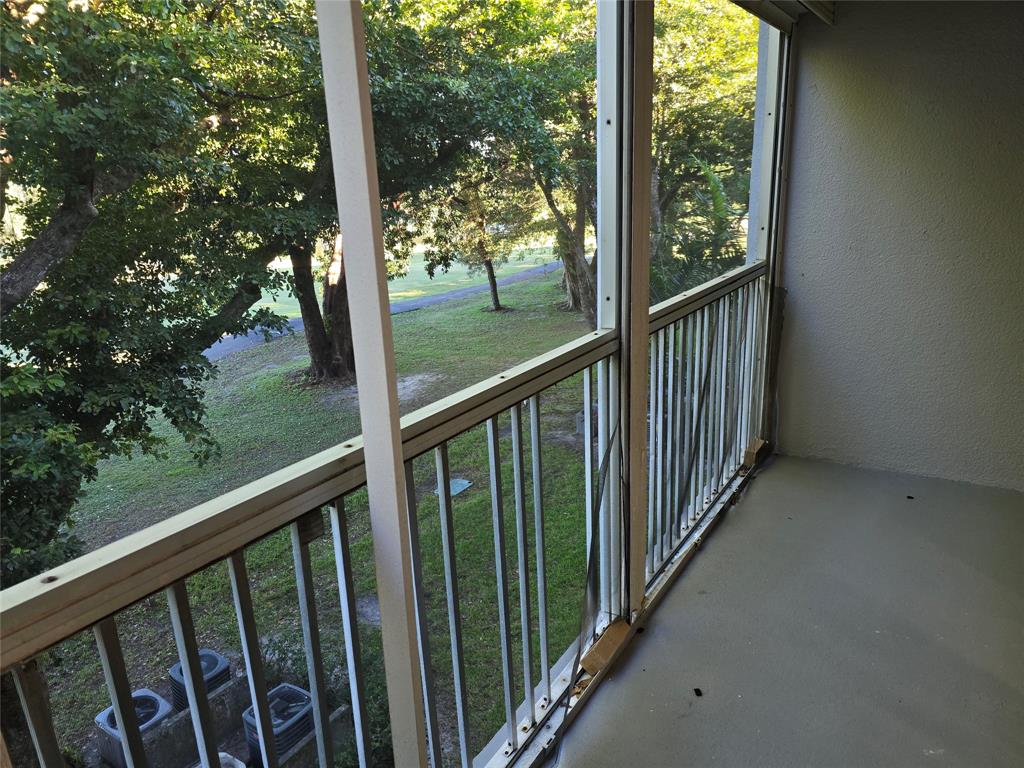 251 Southwest 132nd Way, Unit 308H Pembroke Pines, FL 33027 - Photo 13 of 33 a view of a balcony with wooden fence