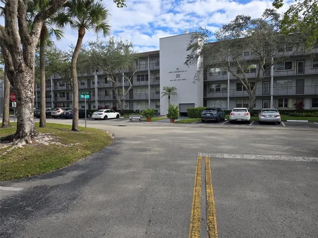 a view of a street with a cars parked in front of it