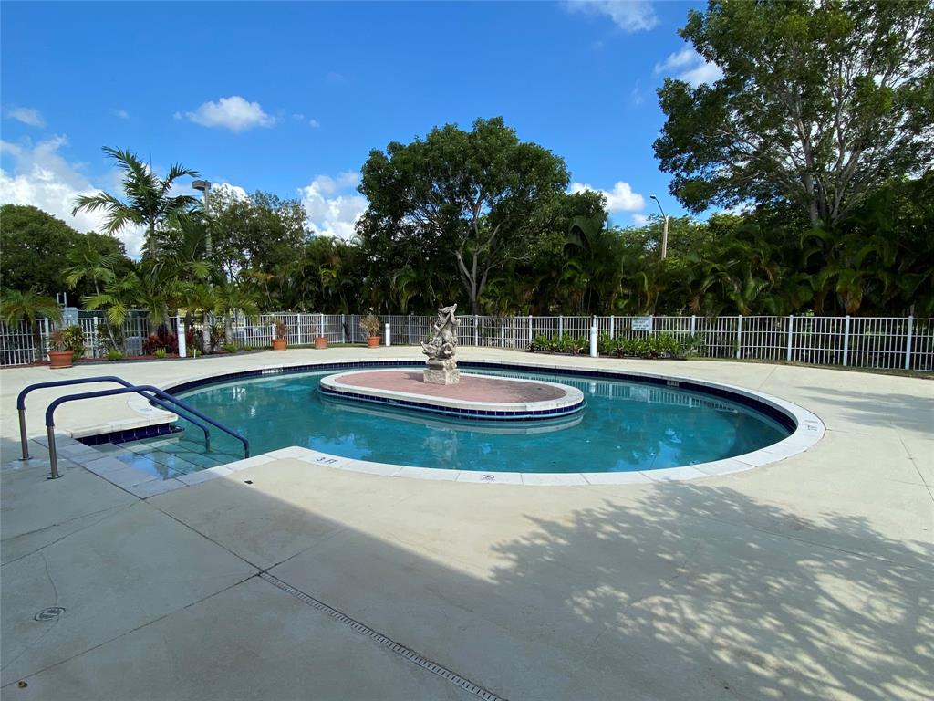 251 Southwest 132nd Way, Unit 308H Pembroke Pines, FL 33027 - Photo 24 of 33 a view of a swimming pool with a yard