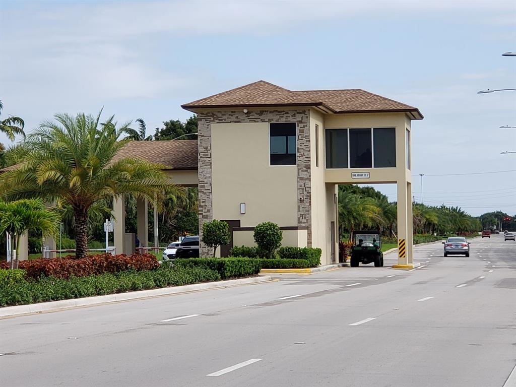 251 Southwest 132nd Way, Unit 308H Pembroke Pines, FL 33027 - Photo 28 of 33 a front view of a house with a yard and garage