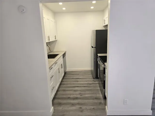 a kitchen with a sink and refrigerator