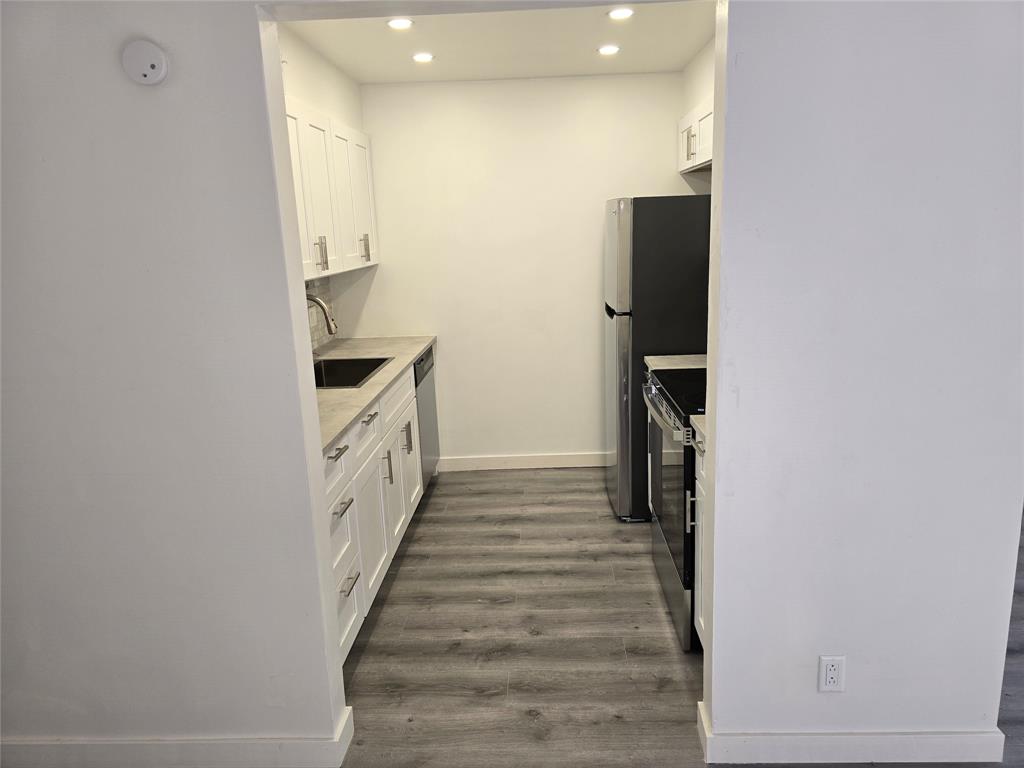 251 Southwest 132nd Way, Unit 308H Pembroke Pines, FL 33027 - Photo 4 of 33 a kitchen with a sink and refrigerator
