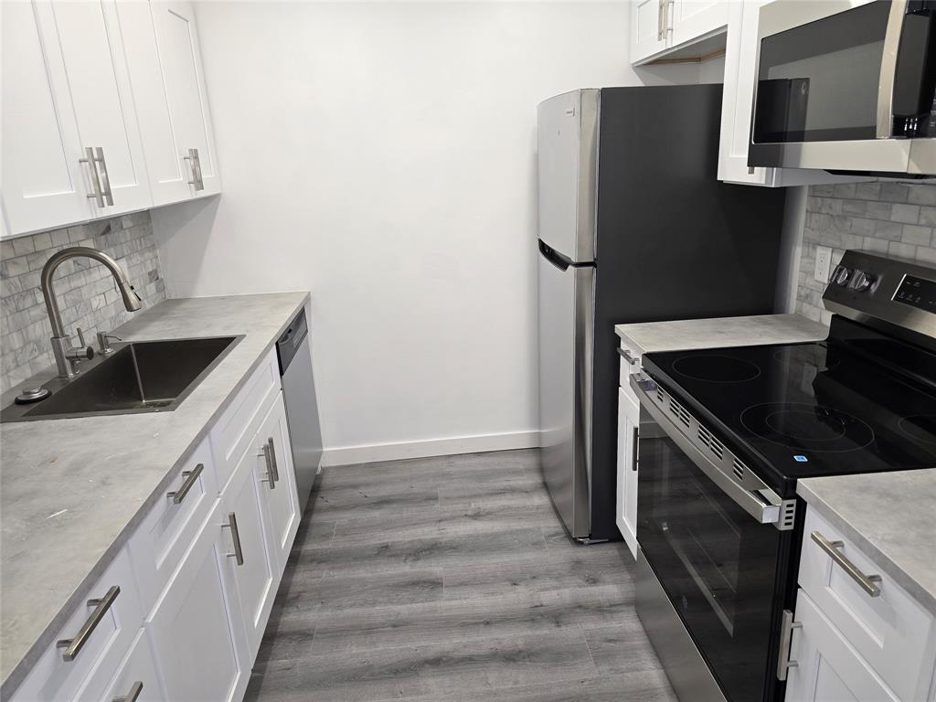 251 Southwest 132nd Way, Unit 308H Pembroke Pines, FL 33027 - Photo 5 of 33 a kitchen with a sink stove and refrigerator