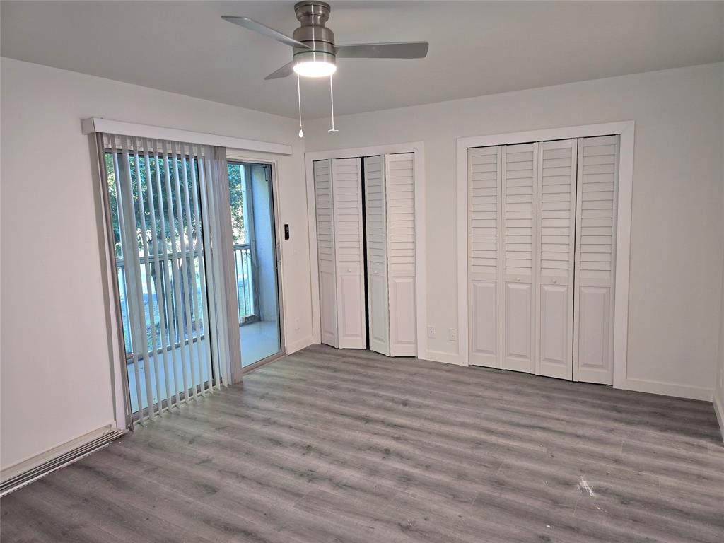 251 Southwest 132nd Way, Unit 308H Pembroke Pines, FL 33027 - Photo 10 of 33 an empty room with wooden floor stairs and a chandelier fan