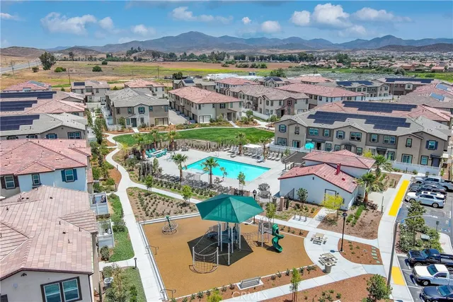an aerial view of residential houses with outdoor space and ocean view