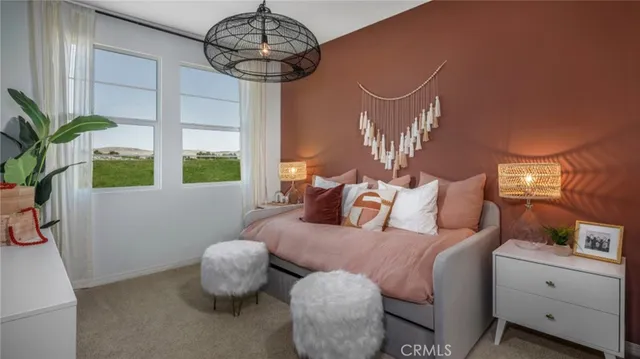 a bedroom with furniture and a large window