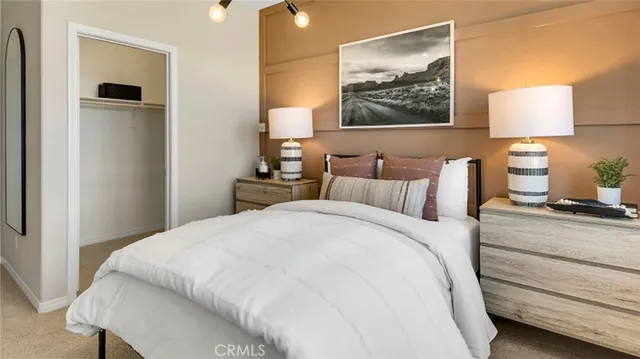 a bedroom with a bed and a painting on the wall