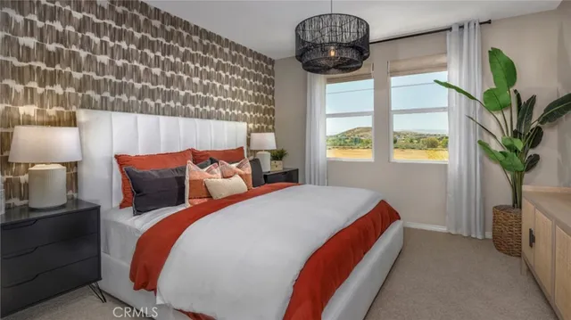 a bed sitting in a bedroom next to a window