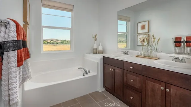 a bathroom with a tub sink and mirror