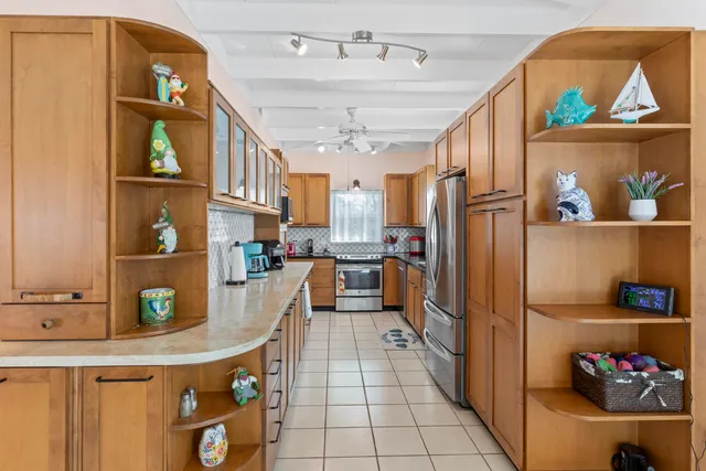 a kitchen with stainless steel appliances granite countertop a refrigerator and a stove