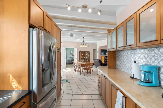 a kitchen with stainless steel appliances granite countertop a refrigerator and a table