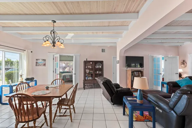 a dining room with furniture a chandelier and window