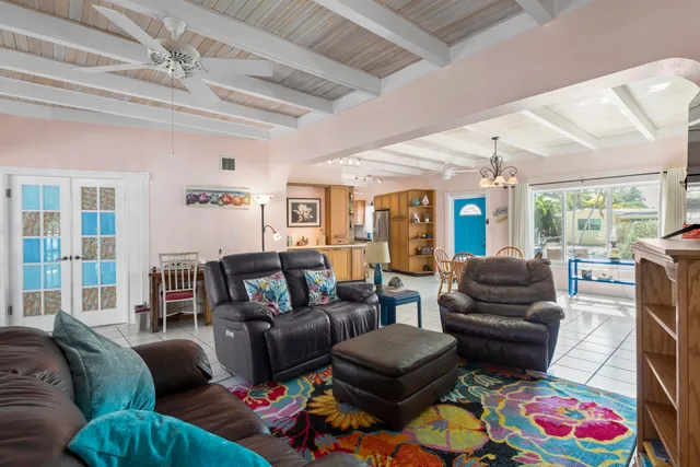 a living room with furniture fireplace and a large window