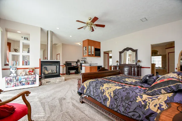 a large kitchen with kitchen island granite countertop a large window and a sink