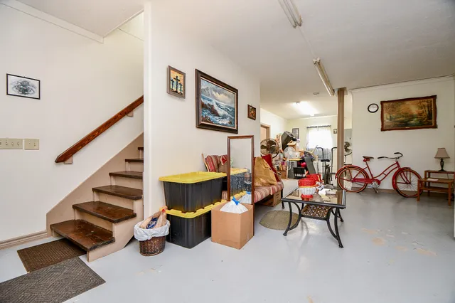 a living room with furniture a ceiling fan and a window