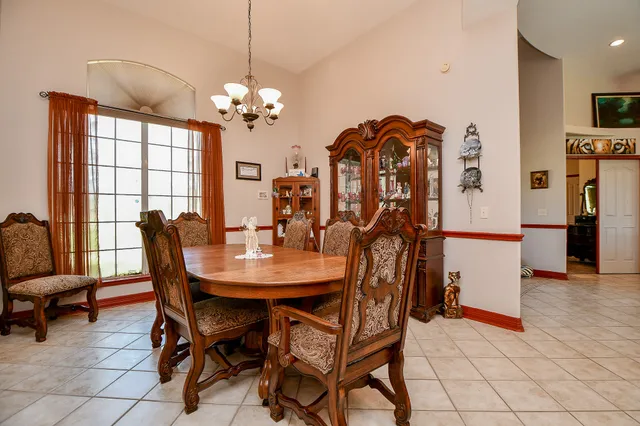 a view of a dining room with furniture and a chandelier