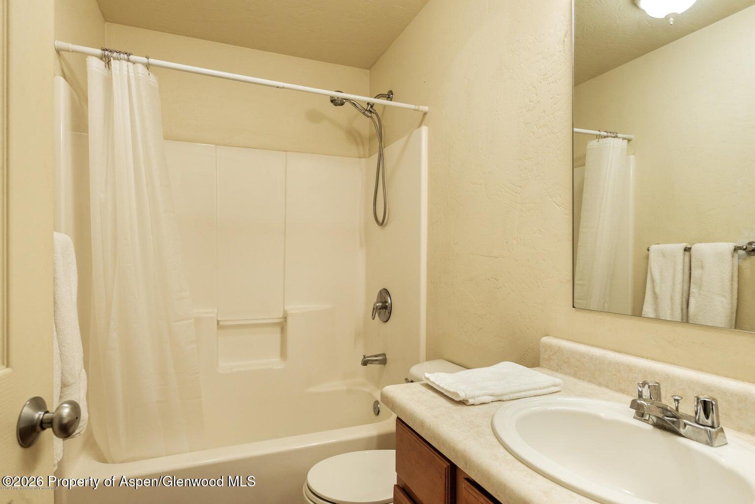 604 Lakeside Drive Basalt, CO 81621 - Photo 10 of 28 a bathroom with a granite countertop sink toilet and shower