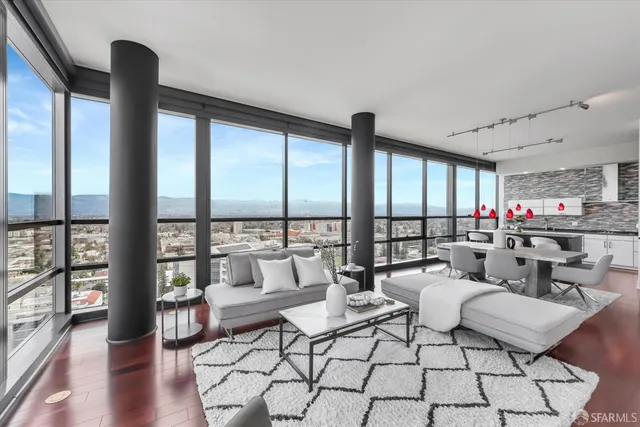 a living room with furniture and a floor to ceiling window