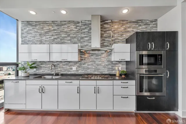 a kitchen with granite countertop a sink cabinets and dining table