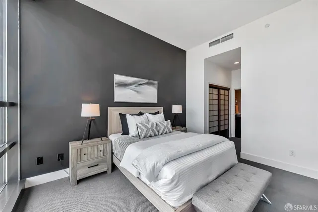 a bedroom with a bed and a chair