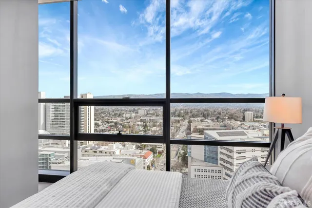 a bedroom with a large bed and a large window