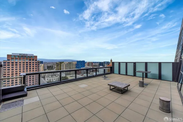 a kitchen with a stove a refrigerator and a dining table with wooden floor