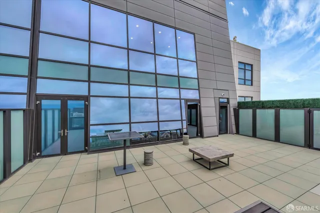 a large kitchen with stainless steel appliances a large counter top a stove and a sink