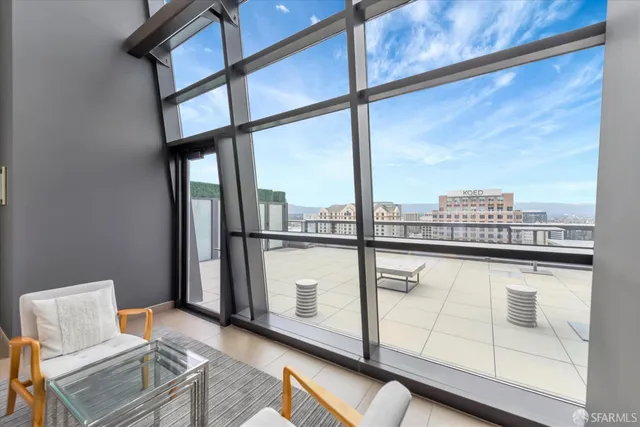 a living room with lots of furniture and a large window