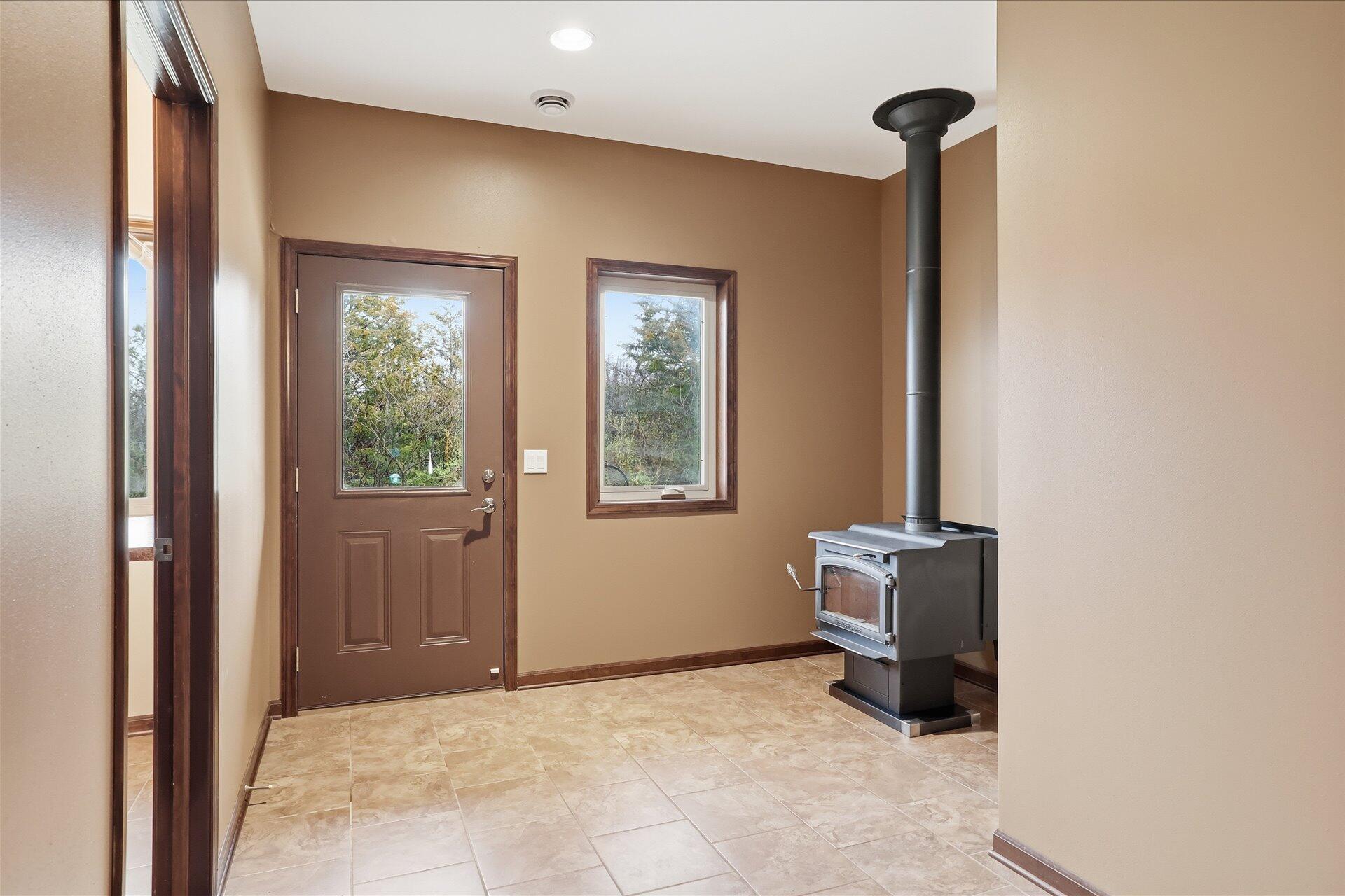 N7026 County DD Spring Prairie, WI 53105 - Photo 5 of 39 Foyer with wood burning stove
