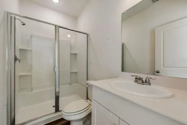 a bathroom with a sink toilet and shower