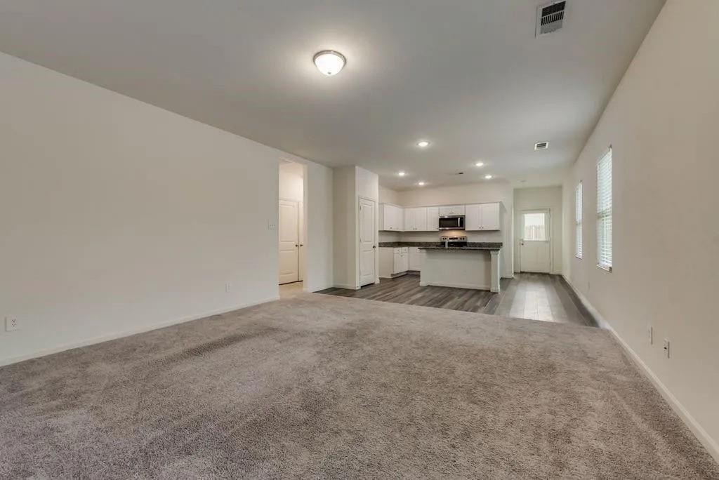 6830 Bonanza Way Forney, TX 75126 - Photo 2 of 14 a view of kitchen with refrigerator stove and a fireplace