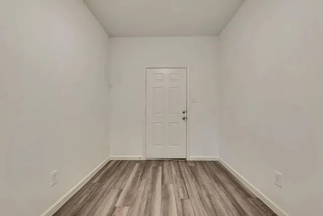 a view of a room with wooden floor