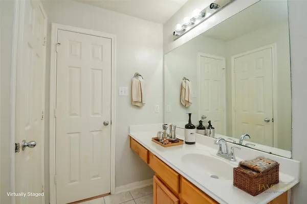 a bathroom with double vanity sink and a mirror