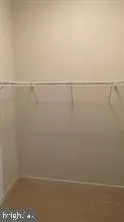 an empty room with wooden floor and closet