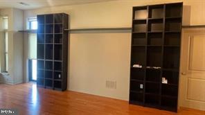 1209 North Charles Street, Unit 302 Baltimore, MD 21201 - Photo 22 of 25 an empty room with wooden floor and closet