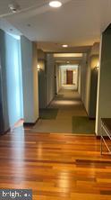 1209 North Charles Street, Unit 302 Baltimore, MD 21201 - Photo 6 of 25 a view of hallway with wooden floor