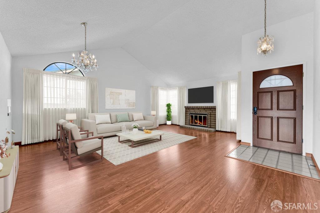 a living room with furniture a fireplace and a flat screen tv