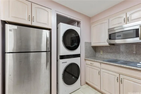 a kitchen with refrigerator and cabinets