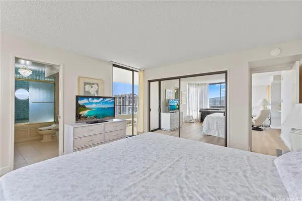 a bedroom with furniture and a flat screen tv