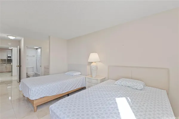 a bedroom with a bed and a lamp