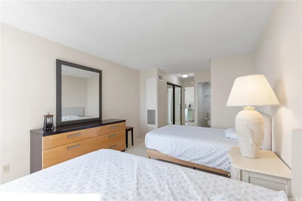 a bedroom with a bed and a mirror