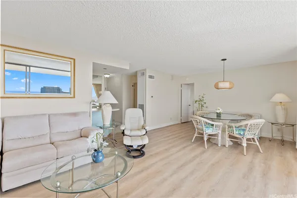a living room with furniture a rug and a chandelier