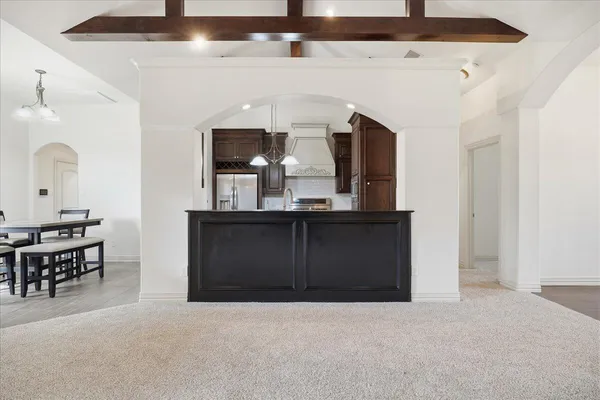 a living room with a table and chairs
