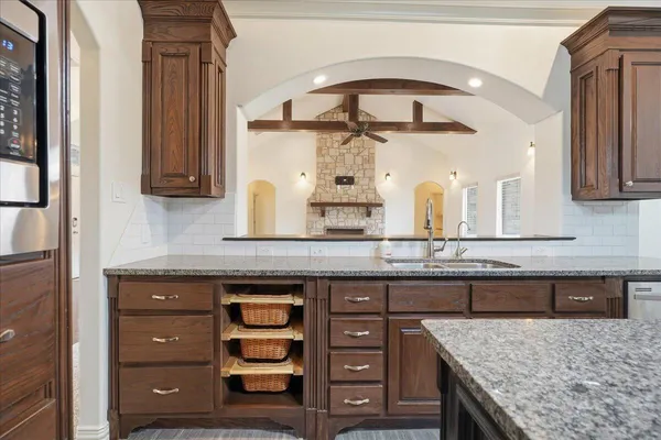 a kitchen with a granite countertop cabinets a island and a stove