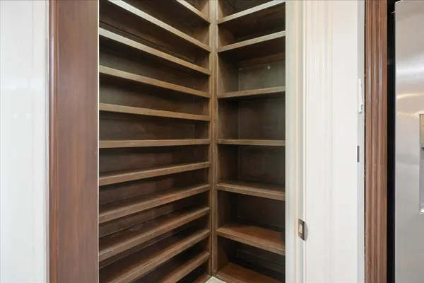 a view of walk in closet with empty racks