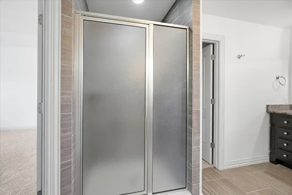 a bathroom with a glass shower door
