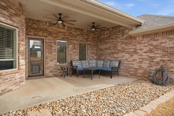 a backyard of a house with table and chairs