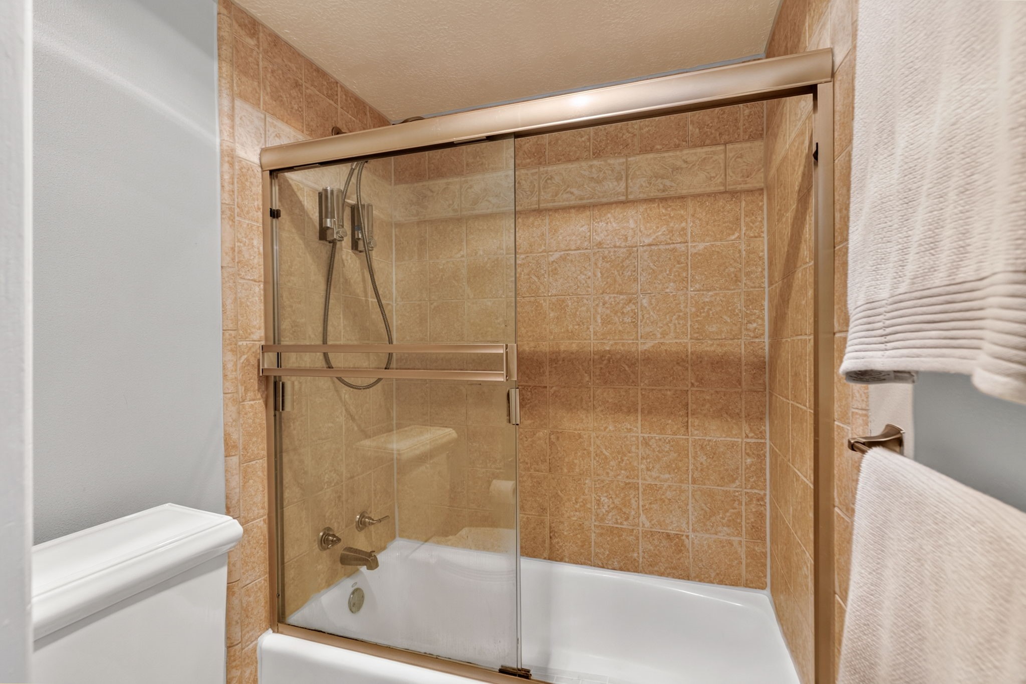 3414 Flaming Candle Drive Spring, TX 77388 - Photo 33 of 50 PRIMARY BATHROOM - Updated Kohler toilet & shower, tub combination.
