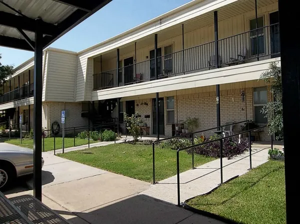 a view of a house with backyard porch and sitting area
